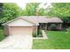 Beautifully maintained home boasts a brick and siding exterior, attached garage, and lush green yard at 610 Front Royal Dr, Indianapolis, IN 46227