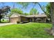Inviting home featuring a brick facade, well-maintained lawn, and mature trees, creating a serene setting at 610 Front Royal Dr, Indianapolis, IN 46227