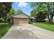 Traditional-style home with a brick exterior, attached garage, long driveway, and a neatly kept lawn at 610 Front Royal Dr, Indianapolis, IN 46227