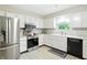 Well-lit kitchen with stainless steel appliances, white cabinets, and bright white countertops at 610 Front Royal Dr, Indianapolis, IN 46227