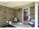 Inviting covered porch with seating, offering a cozy spot to relax outside the home's entrance at 610 Front Royal Dr, Indianapolis, IN 46227