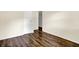 Well-lit bedroom with wood-look floors, storage closet, and neutral walls, ideal for relaxation at 6108 Penway St, Indianapolis, IN 46224