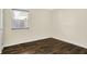 This is a bright bedroom with wood-look flooring and natural light coming through the window at 6108 Penway St, Indianapolis, IN 46224