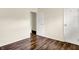 Bedroom showcasing wood-look floors, neutral walls, closet space and an open doorway at 6108 Penway St, Indianapolis, IN 46224
