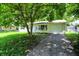 Charming home with garage and driveway partially shaded by a mature tree at 6108 Penway St, Indianapolis, IN 46224