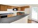 Bright kitchen with dark countertops, light wood cabinets, and a breakfast bar, perfect for entertaining at 6108 Penway St, Indianapolis, IN 46224