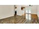 Open-concept living room with hardwood floors leading to a kitchen and back door at 6108 Penway St, Indianapolis, IN 46224