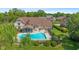 Aerial view of the backyard, showcasing a pool, mature landscaping, and an enclosed patio area at 625 La Placita St, Greenwood, IN 46143