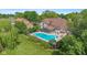 Aerial view of backyard featuring a large in-ground pool, patio area, and lush landscaping at 625 La Placita St, Greenwood, IN 46143