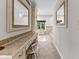 Bathroom hallway featuring vanity, mirrors, and access to the main bath at 625 La Placita St, Greenwood, IN 46143