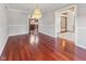 Dining room showcasing wood flooring, a chandelier, and a view into the adjacent rooms at 625 La Placita St, Greenwood, IN 46143