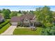 Beautiful home featuring manicured lawn, charming fountain, and attached garage, offering suburban appeal at 625 La Placita St, Greenwood, IN 46143
