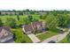 Stunning Tudor-style home with lush landscaping and a well-manicured lawn backing up to the golf course at 625 La Placita St, Greenwood, IN 46143