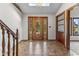 Elegant foyer featuring tile flooring, a decorative wood door, and a skylight at 625 La Placita St, Greenwood, IN 46143