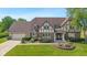 Charming Tudor style home with well-manicured lawn, mature trees, and beautiful landscaping at 625 La Placita St, Greenwood, IN 46143