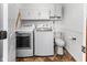 Bright laundry room features a washer, dryer, toilet and upper storage cabinets at 625 La Placita St, Greenwood, IN 46143