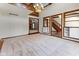 Large living room with carpet, chandelier, and doorway views of the brick fireplace and wooden staircase at 625 La Placita St, Greenwood, IN 46143
