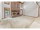 Living room boasts high ceilings, a brick fireplace, and views of the outdoor pool at 625 La Placita St, Greenwood, IN 46143