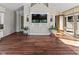 Inviting living room showcasing hardwood floors, TV, decorative shelving, and access to the outdoors at 625 La Placita St, Greenwood, IN 46143