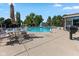 Backyard pool area, complete with a diving board, slide, surrounding greenery, and outdoor seating at 625 La Placita St, Greenwood, IN 46143