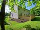 Backyard featuring a spacious wooden deck, lush green lawn, and tasteful landscaping for outdoor enjoyment at 6483 Timber Walk Dr, Indianapolis, IN 46236