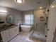 Bathroom featuring double vanity, soaking tub, and tiled walk-in shower with glass enclosure at 6483 Timber Walk Dr, Indianapolis, IN 46236