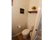 Cozy bathroom featuring a toilet, decorative wall art, shelf decor, and a functional toilet paper holder at 6483 Timber Walk Dr, Indianapolis, IN 46236