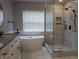 Bathroom featuring double vanity, soaking tub, and tiled walk-in shower at 6483 Timber Walk Dr, Indianapolis, IN 46236