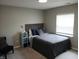 Bedroom with carpet, a large window for natural light, and a comfortable bed at 6483 Timber Walk Dr, Indianapolis, IN 46236