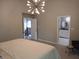 Bright bedroom with modern lighting and easy access to an adjoining bathroom and staircase at 6483 Timber Walk Dr, Indianapolis, IN 46236