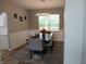 Elegant dining room with wainscoting, modern lighting, and large window with backyard view at 6483 Timber Walk Dr, Indianapolis, IN 46236