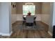 Elegant dining room with wainscoting, stylish lighting, and a large window, ideal for Gathering gatherings at 6483 Timber Walk Dr, Indianapolis, IN 46236