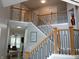 Grand two-story foyer with wood and iron railing, showcasing an open layout and abundant natural light at 6483 Timber Walk Dr, Indianapolis, IN 46236