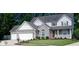 Charming two-story home with a brick facade, white siding, attached garage, and well-manicured lawn at 6483 Timber Walk Dr, Indianapolis, IN 46236