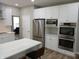 Modern kitchen with white cabinets, stainless steel appliances, and large center island at 6483 Timber Walk Dr, Indianapolis, IN 46236