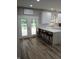 Bright, modern kitchen with island, white cabinets, stainless appliances and exterior deck access at 6483 Timber Walk Dr, Indianapolis, IN 46236
