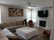 A modern living room with fireplace, large sectional sofa, and hardwood floors at 6483 Timber Walk Dr, Indianapolis, IN 46236