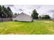 Spacious backyard with a well-maintained lawn and a partial view of the home's exterior at 6640 Chipping Ct, Indianapolis, IN 46268