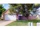 Brick home with an attached two-car garage and fenced yard at 6640 Chipping Ct, Indianapolis, IN 46268