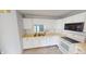 Bright kitchen with white cabinetry, laminate countertops, and modern appliances at 6640 Chipping Ct, Indianapolis, IN 46268