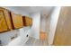 Clean laundry area with overhead cabinets and vinyl flooring at 6640 Chipping Ct, Indianapolis, IN 46268