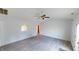 Bright living area featuring grey flooring, access to the backyard, and plenty of natural light at 6640 Chipping Ct, Indianapolis, IN 46268