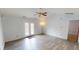 Spacious living room with vaulted ceiling, ceiling fan, and access to outdoor patio at 6640 Chipping Ct, Indianapolis, IN 46268