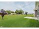 Expansive backyard featuring well-maintained green lawn, wooden sheds, mature trees and a garden at 6644 Aberdeen Dr, McCordsville, IN 46055