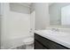 Bathroom with a shower-tub combo, dark vanity with white sink, and a large mirror at 6644 Aberdeen Dr, McCordsville, IN 46055