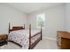 Bedroom features neutral paint, carpet, and a dark wood bed frame at 6644 Aberdeen Dr, McCordsville, IN 46055