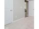 Bright bedroom featuring neutral carpet and paint, and white doors with entry to the living room at 6644 Aberdeen Dr, McCordsville, IN 46055