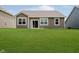Back exterior of home with brown vinyl siding, sliding glass door, and large grassy yard at 6644 Aberdeen Dr, McCordsville, IN 46055