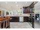 Bright kitchen with stainless steel appliances, granite counters, and luxury vinyl plank flooring at 6644 Aberdeen Dr, McCordsville, IN 46055