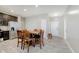 Open-concept kitchen with stainless steel appliances, dark wood cabinets, and luxury vinyl plank flooring at 6644 Aberdeen Dr, McCordsville, IN 46055